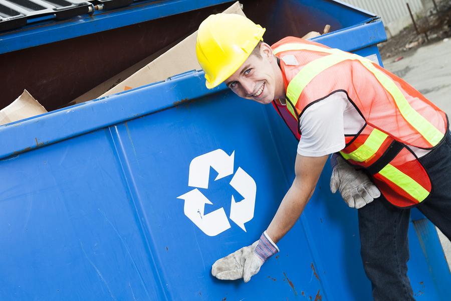 A worker who recycling thing on recycle center on the recycle garbage border