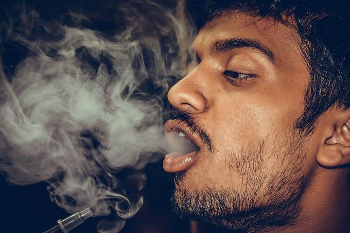man with smoke in his mouth